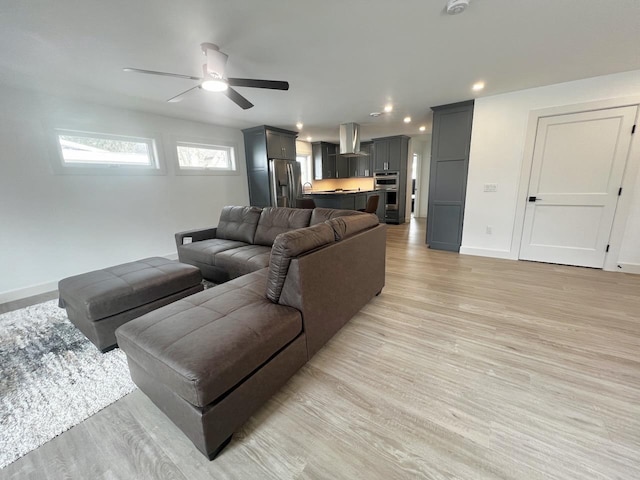 living area featuring recessed lighting, light wood-type flooring, baseboards, and ceiling fan