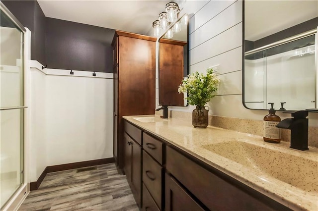 820 Rusty Ct, Altoona, WI 54720 - full bath with wood finished floors, a shower with door, double vanity, and baseboards