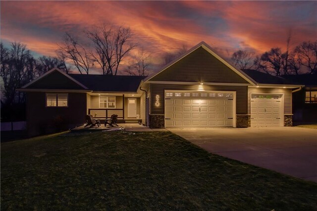 820 Rusty Ct, Altoona, WI 54720 - view of front of home with an attached garage, concrete driveway, a front lawn, and stone siding