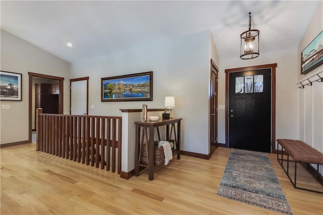820 Rusty Ct, Altoona, WI 54720 - foyer featuring light wood-type flooring, baseboards, vaulted ceiling, and a chandelier