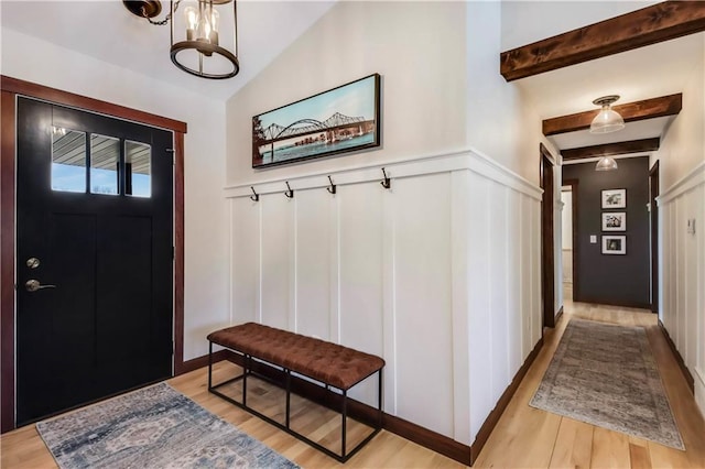 820 Rusty Ct, Altoona, WI 54720 - foyer featuring a decorative wall, light wood-style floors, a wainscoted wall, a chandelier, and lofted ceiling