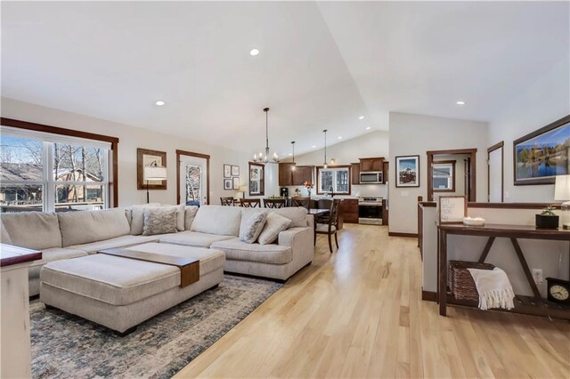 820 Rusty Ct, Altoona, WI 54720 - living area featuring vaulted ceiling, a chandelier, light wood-style flooring, and recessed lighting