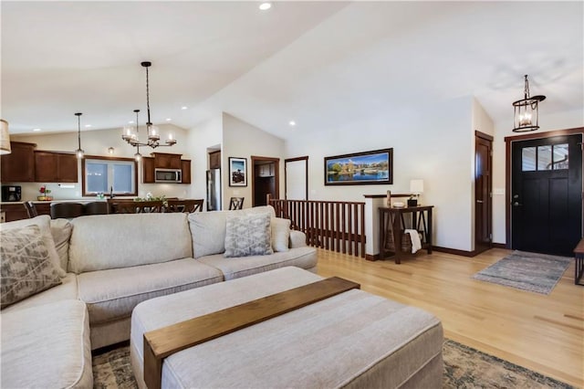 820 Rusty Ct, Altoona, WI 54720 - living room with a chandelier, vaulted ceiling, light wood-style flooring, recessed lighting, and baseboards