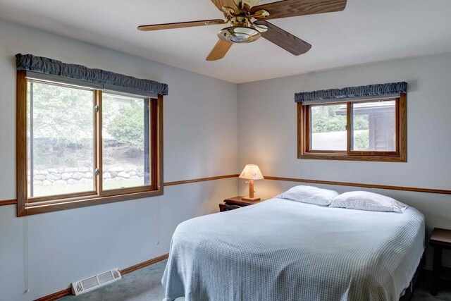 W5854 Bubbling Springs Dr, Elkhorn, WI 53121 - carpeted bedroom with visible vents, baseboards, and a ceiling fan