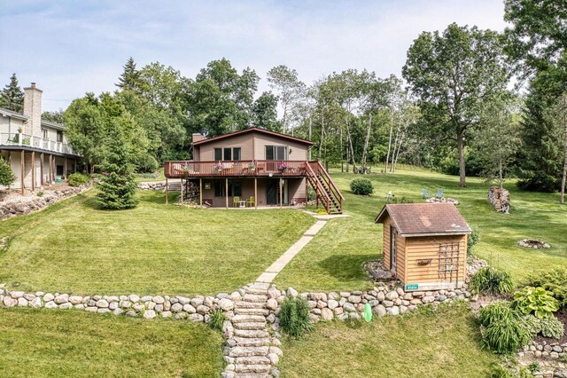 W5854 Bubbling Springs Dr, Elkhorn, WI 53121 - back of house featuring stairs, a yard, an outdoor structure, and a wooden deck