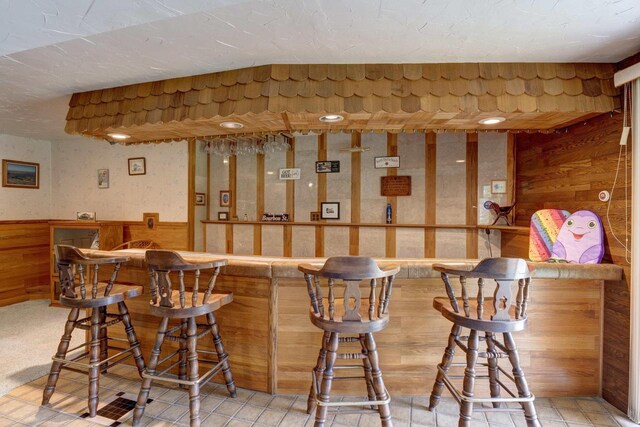 W5854 Bubbling Springs Dr, Elkhorn, WI 53121 - bar with wooden walls, wainscoting, and indoor bar