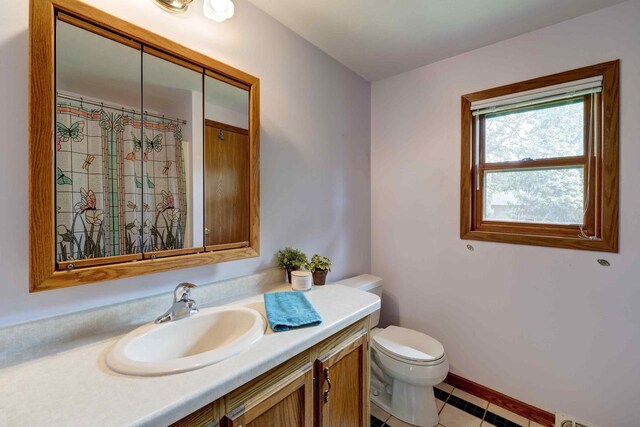 W5854 Bubbling Springs Dr, Elkhorn, WI 53121 - bathroom with vanity, tile patterned flooring, visible vents, toilet, and curtained shower