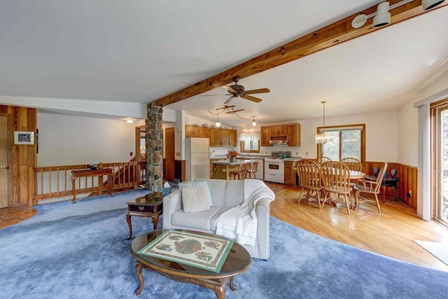W5854 Bubbling Springs Dr, Elkhorn, WI 53121 - living room with beam ceiling, a wainscoted wall, light wood-style floors, and ceiling fan with notable chandelier