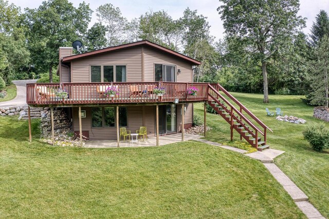 W5854 Bubbling Springs Dr, Elkhorn, WI 53121 - back of house featuring a chimney, stairway, a patio area, a wooden deck, and a yard