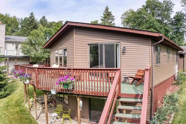W5854 Bubbling Springs Dr, Elkhorn, WI 53121 - rear view of house featuring a wooden deck and a lawn