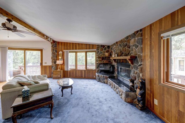 W5854 Bubbling Springs Dr, Elkhorn, WI 53121 - carpeted living area featuring wood walls, lofted ceiling with beams, a ceiling fan, and a healthy amount of sunlight