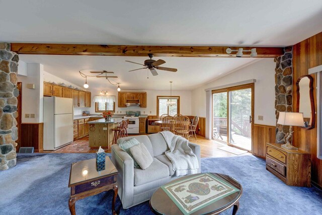 W5854 Bubbling Springs Dr, Elkhorn, WI 53121 - living area featuring wood walls, a wainscoted wall, ceiling fan, and light colored carpet