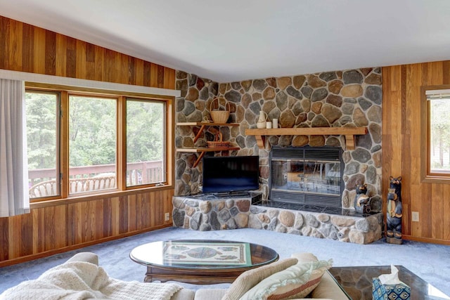 W5854 Bubbling Springs Dr, Elkhorn, WI 53121 - carpeted living area with wood walls, a stone fireplace, and baseboards