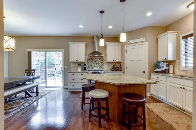 6679 S Chickahauk Trl, Middleton, WI 53562 - kitchen featuring stainless steel range oven, white cabinets, wall chimney range hood, and a center island