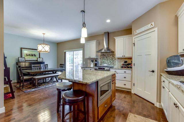 6679 S Chickahauk Trl, Middleton, WI 53562 - kitchen with wall chimney range hood, dark wood-style floors, tasteful backsplash, and stainless steel appliances