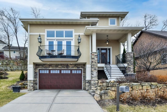 6679 S Chickahauk Trl, Middleton, WI 53562 - view of front of property with concrete driveway, stucco siding, stone siding, a balcony, and a garage