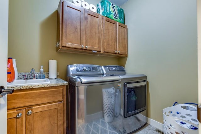 6679 S Chickahauk Trl, Middleton, WI 53562 - laundry room with washing machine and clothes dryer, cabinet space, a sink, and baseboards