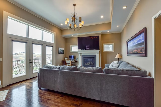 6679 S Chickahauk Trl, Middleton, WI 53562 - living room with a notable chandelier, ornamental molding, dark wood-type flooring, and a glass covered fireplace