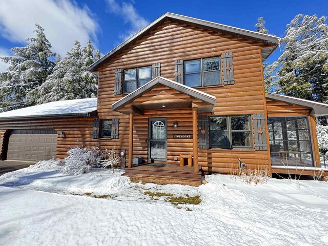 7118 Timber Ln, Rhinelander, WI 54501 - view of front of property featuring an attached garage and a sunroom