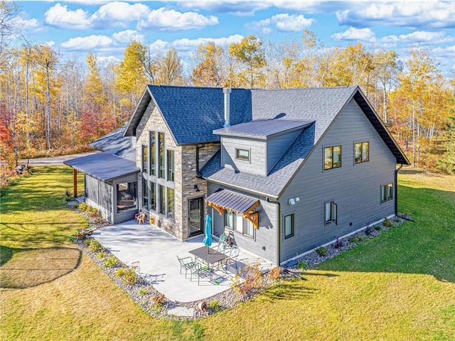 11684 Brook Ln, Hayward, WI 54843 - rear view of property with a patio area, a shingled roof, stone siding, and a yard
