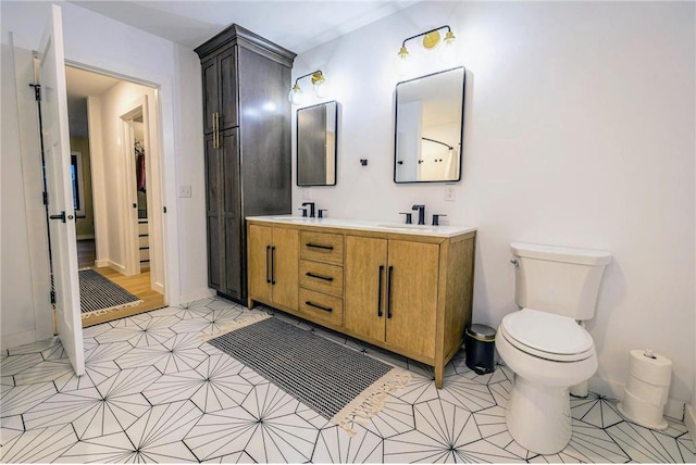 11684 Brook Ln, Hayward, WI 54843 - full bath with toilet, tile patterned floors, double vanity, and a sink