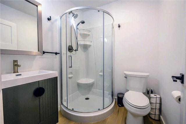 11684 Brook Ln, Hayward, WI 54843 - bathroom featuring a shower stall, toilet, and wood finished floors