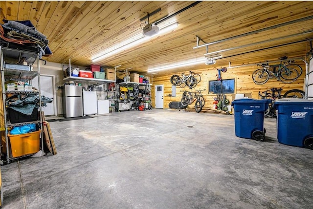 11684 Brook Ln, Hayward, WI 54843 - garage with freestanding refrigerator and a garage door opener