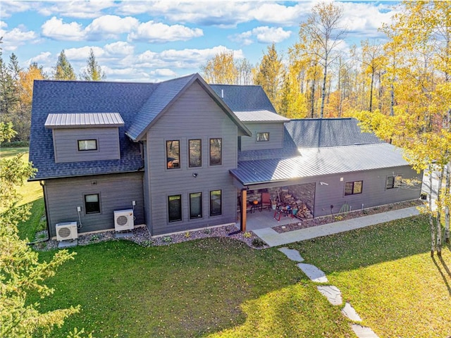 11684 Brook Ln, Hayward, WI 54843 - back of property with a patio area, ac unit, metal roof, and a lawn