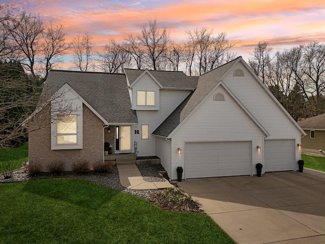 119 Vilas Hibbard Pkwy, Lodi, WI 53555 - traditional-style house with roof with shingles, driveway, brick siding, a garage, and a lawn
