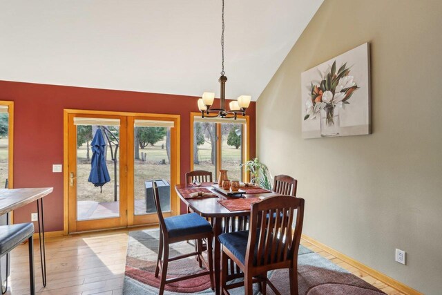 119 Vilas Hibbard Pkwy, Lodi, WI 53555 - dining room with a notable chandelier, french doors, wood finished floors, lofted ceiling, and baseboards