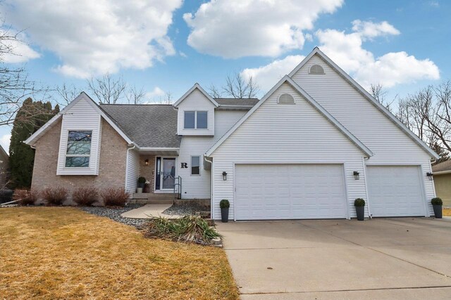 119 Vilas Hibbard Pkwy, Lodi, WI 53555 - view of front of home featuring driveway, roof with shingles, brick siding, a front lawn, and a garage