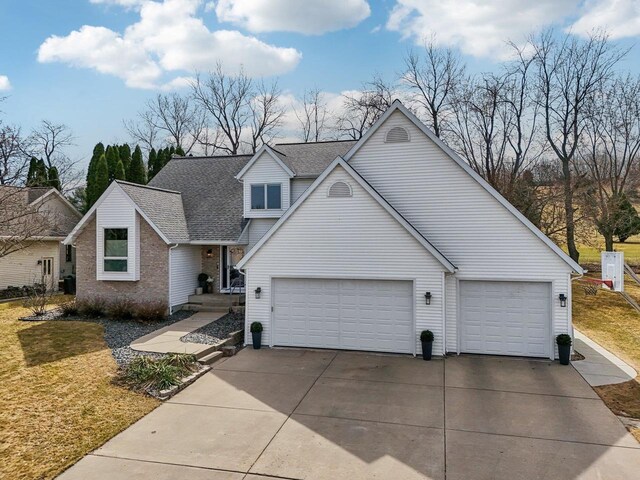 119 Vilas Hibbard Pkwy, Lodi, WI 53555 - traditional home featuring a shingled roof, concrete driveway, brick siding, and a front yard