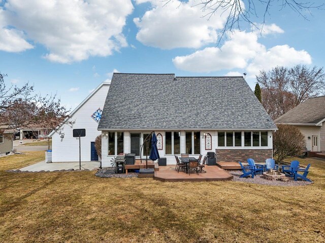 119 Vilas Hibbard Pkwy, Lodi, WI 53555 - rear view of property featuring a patio, an outdoor fire pit, roof with shingles, and a yard