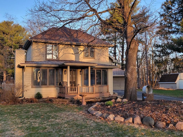 2215 N Shore Dr, Delavan, WI 53115 - view of front of home featuring a front yard, a porch, and a garage