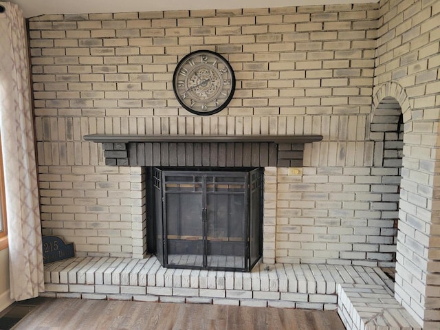 2215 N Shore Dr, Delavan, WI 53115 - details with visible vents, wood finished floors, and a brick fireplace