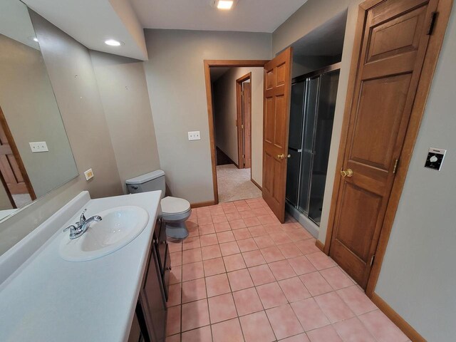 2215 N Shore Dr, Delavan, WI 53115 - bathroom featuring vanity, toilet, baseboards, tile patterned floors, and a stall shower