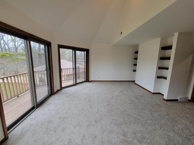 2215 N Shore Dr, Delavan, WI 53115 - interior space with high vaulted ceiling, carpet, baseboards, and visible vents