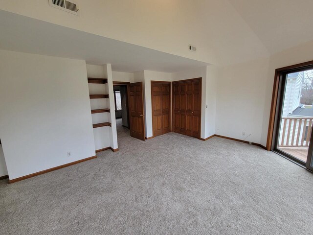 2215 N Shore Dr, Delavan, WI 53115 - spare room with light colored carpet, visible vents, high vaulted ceiling, and baseboards