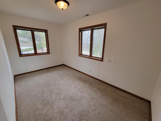2215 N Shore Dr, Delavan, WI 53115 - carpeted empty room with baseboards and visible vents