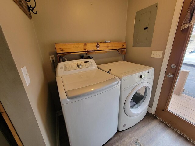 2215 N Shore Dr, Delavan, WI 53115 - laundry room with electric panel, washer and clothes dryer, light wood-style flooring, and laundry area