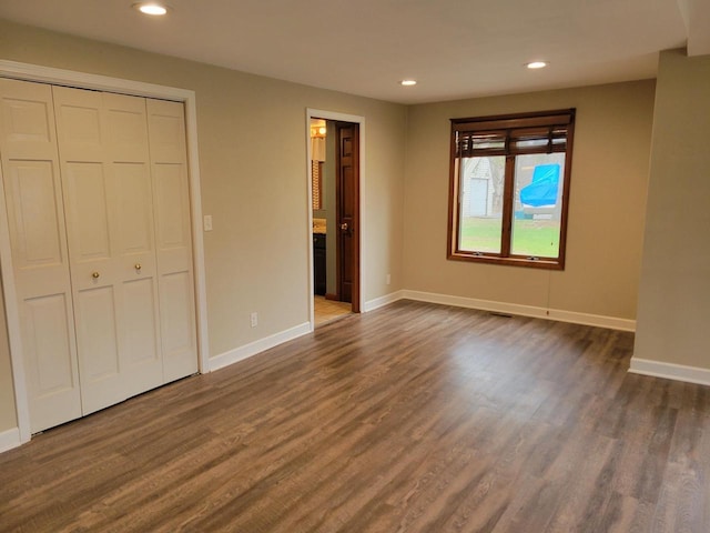 2215 N Shore Dr, Delavan, WI 53115 - unfurnished bedroom featuring dark wood-style flooring, a closet, baseboards, and recessed lighting