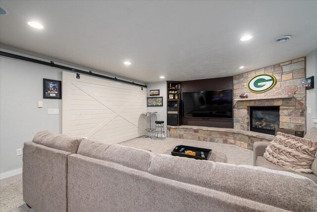 3265 Casey Trl, Oshkosh, WI 54904 - living area with carpet flooring, a barn door, a fireplace, and recessed lighting