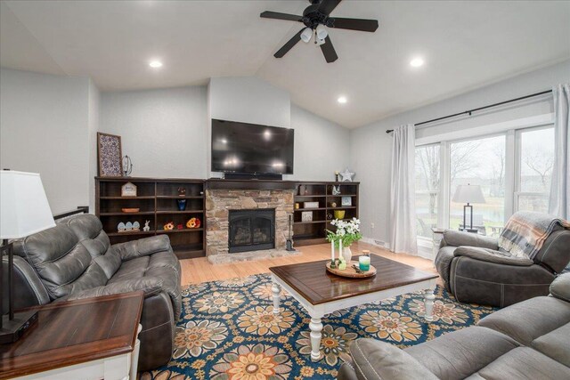3265 Casey Trl, Oshkosh, WI 54904 - living room featuring vaulted ceiling, a ceiling fan, wood finished floors, a stone fireplace, and recessed lighting