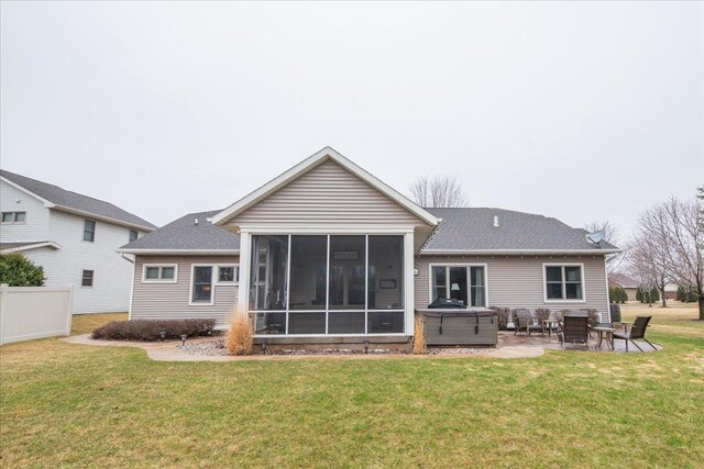 3265 Casey Trl, Oshkosh, WI 54904 - rear view of property featuring a sunroom, a patio area, a hot tub, and a yard