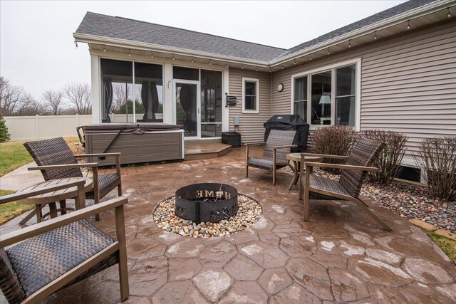 3265 Casey Trl, Oshkosh, WI 54904 - view of patio with a hot tub, a sunroom, fence, and an outdoor fire pit