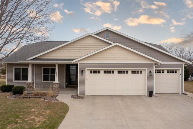 3265 Casey Trl, Oshkosh, WI 54904 - view of front of house featuring an attached garage, a shingled roof, and concrete driveway