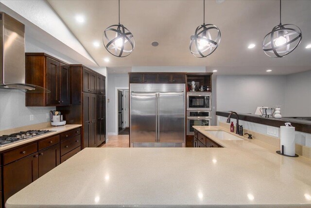 3265 Casey Trl, Oshkosh, WI 54904 - kitchen featuring vaulted ceiling, a sink, built in appliances, dark brown cabinets, and wall chimney exhaust hood