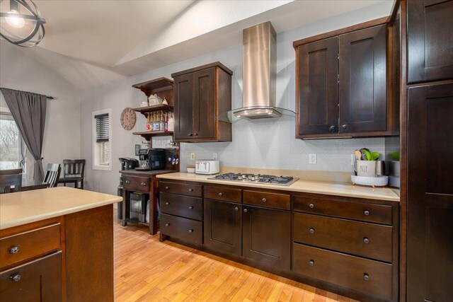 3265 Casey Trl, Oshkosh, WI 54904 - kitchen featuring light countertops, stainless steel gas cooktop, lofted ceiling, open shelves, and wall chimney exhaust hood
