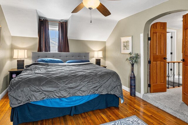 3304 Nicolet Dr, Green Bay, WI 54311 - bedroom featuring vaulted ceiling, a ceiling fan, baseboards, arched walkways, and hardwood / wood-style floors