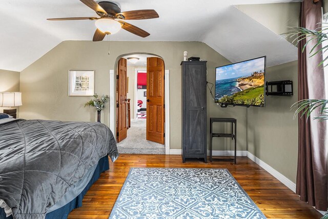 3304 Nicolet Dr, Green Bay, WI 54311 - bedroom featuring arched walkways, baseboards, vaulted ceiling, and wood finished floors